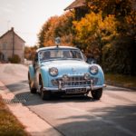 blue classic car on road during daytime